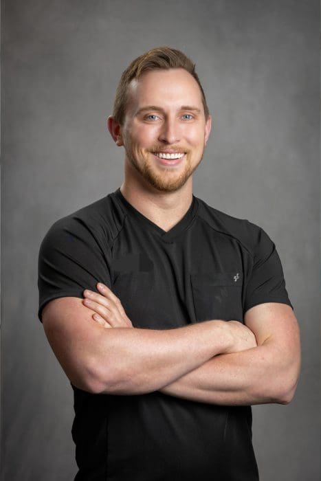 Man smiling with arms crossed