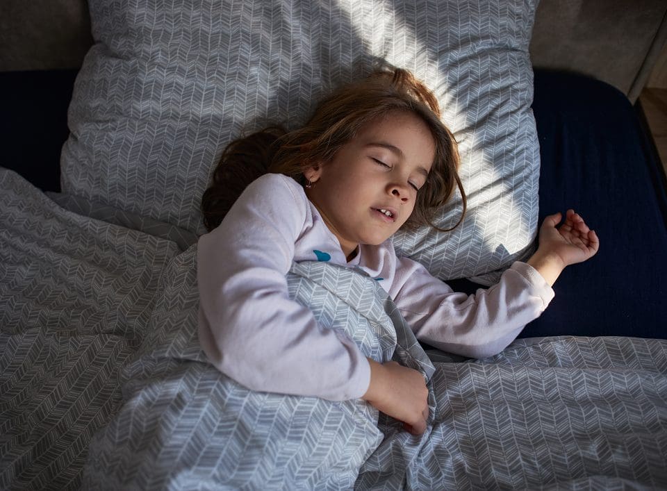 Child sleeping peacefully in bed