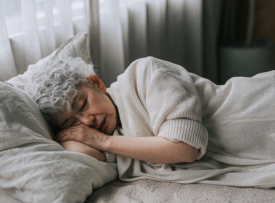 Older adult napping in cozy room