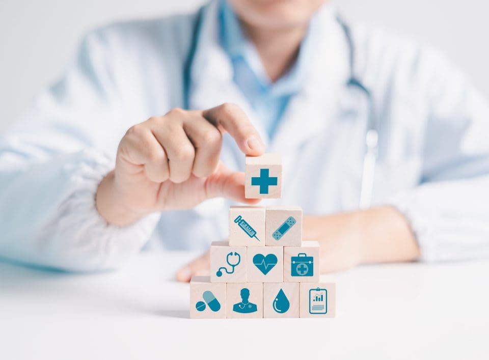 Building healthcare pyramid with icons